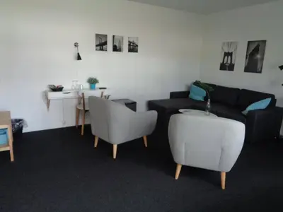 a living room with a couch and chairs and a table at Hotel St. Binderup in Store Binderup