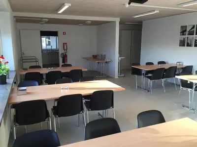 a classroom with tables and chairs in a room at Danhostel Thyborøn in Thyborøn