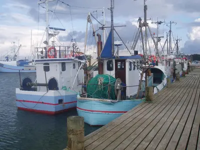 two boats docked at a dock in the water at Strandhuset Holiday Home in Glyngøre
