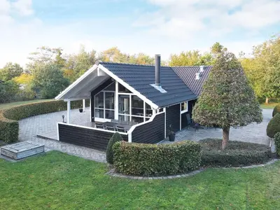 a small house with a black roof at 7 person holiday home in Løgstør-By Traum in Trend