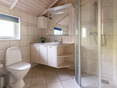 a bathroom with a toilet and a shower and a sink at 7 person holiday home in Løgstør-By Traum in Trend