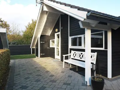 a porch with a white bench on a house at 7 person holiday home in Løgstør-By Traum in Trend
