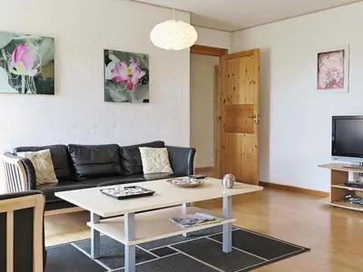 a living room with a couch and a coffee table at 6 person holiday home in Lemvig-By Traum in Ferring