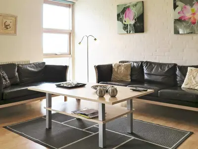 a living room with a couch and a coffee table at 6 person holiday home in Lemvig-By Traum in Ferring