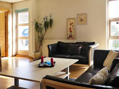 a living room with a couch and a table at 6 person holiday home in Lemvig-By Traum in Ferring