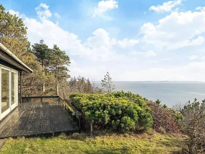 a porch of a house with a view of the ocean at Secluded Beach Retreat - By Traum Ferienwohnungen in Lihme