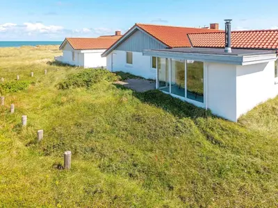 a house on the side of a grassy hill at 8 person holiday home in Frøstrup-By Traum in Lild Strand