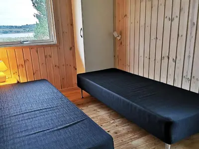 a room with two beds and a window at 10 person holiday home in Højslev-By Traum in Lund