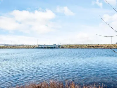 a large body of water with a bridge in the background at 10 person holiday home in Højslev-By Traum in Lund