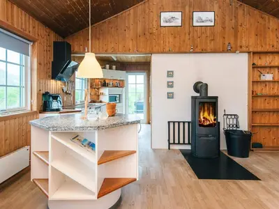 a kitchen and living room with a fireplace at 12 person holiday home in Harboøre-By Traum in Vrist