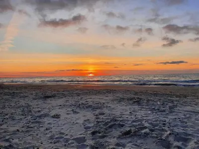 a sunset on a beach with the ocean at 8 person holiday home in Fjerritslev-By Traum in Torup Strand