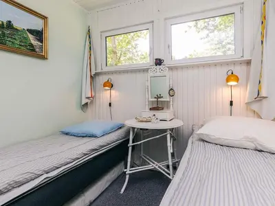a small room with two beds and a table at 2 person holiday home in Thyholm-By Traum in Thyholm