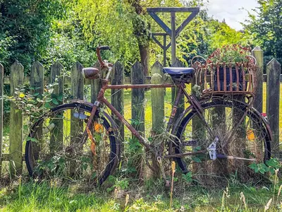 an old bike parked in front of a fence at 2 person holiday home in Thyholm-By Traum in Thyholm