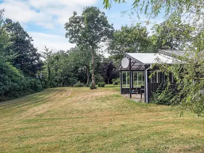 a small building in the middle of a field at 2 person holiday home in Thyholm-By Traum in Thyholm