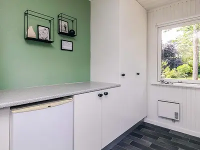 a kitchen with white cabinets and a window at 2 person holiday home in Thyholm-By Traum in Thyholm