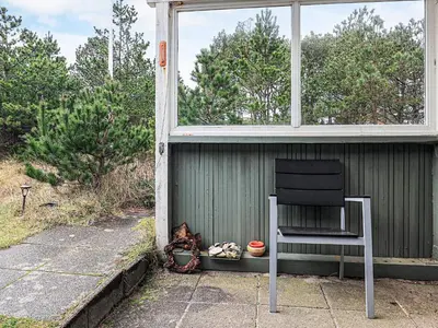 a chair sitting in the window of a house at 6 person holiday home in Thisted-By Traum in Sønder Vorupør
