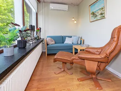 a living room with a chair and a couch at 19 person holiday home in Løgstør-By Traum in Trend