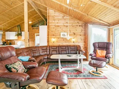 a living room with a leather couch and a table at 9 person holiday home in Hurup Thy-By Traum in Sindrup