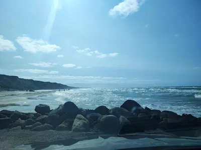 a group of rocks on a beach near the water at 6 person holiday home in Saltum-By Traum in Saltum