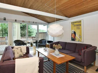 a living room with a couch and a table at 6 person holiday home in Saltum-By Traum in Saltum