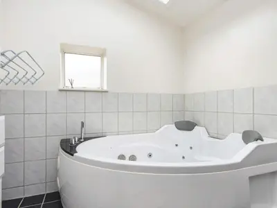 a white bath tub in a bathroom with a window at 7 person holiday home in Struer-By Traum in Humlum