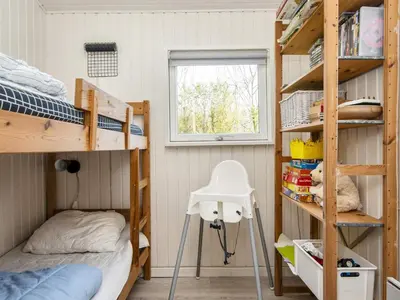 a small bedroom with bunk beds and a window at 7 person holiday home in Struer-By Traum in Humlum