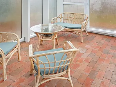 a patio with chairs and a table and a glass table at Luxury Retreat with Pool - By Traum Ferienwohnungen in Hvalpsund