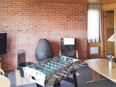 a ping pong table in front of a brick wall at Seaside Retreat with Sauna - By Traum Ferienwohnungen in Vrist