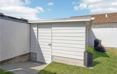 a white garage door on a house at Two-Bedroom Holiday Home In Pandrup in Pandrup