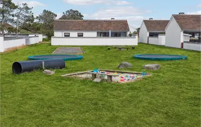 a group of trampolines in a grassy yard at Two-Bedroom Holiday Home In Pandrup in Pandrup