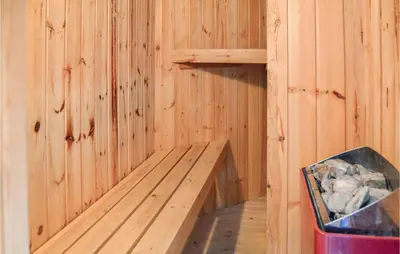 a wooden sauna with a wooden bench in it at Four-Bedroom Holiday Home In Thisted in Thisted