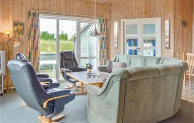a living room with a couch and chairs and a table at Four-Bedroom Holiday Home In Thisted in Thisted