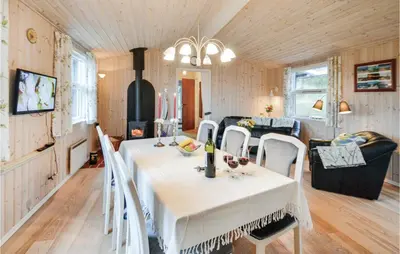 a dining room with a white table and chairs at Two-Bedroom Holiday Home In Thisted in Thisted