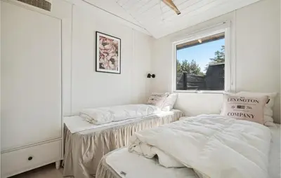 a bedroom with two beds and a window at Three-Bedroom Holiday Home In Thisted in Nørre Vorupør