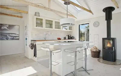 a kitchen with a white island and a stove at Three-Bedroom Holiday Home In Thisted in Nørre Vorupør