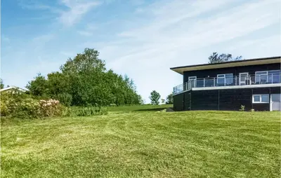 a house with a large yard in front of it at Three-Bedroom Holiday Home In Spottrup in Spottrup