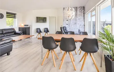 a dining room with a table and chairs at Three-Bedroom Holiday Home In Spottrup in Spottrup