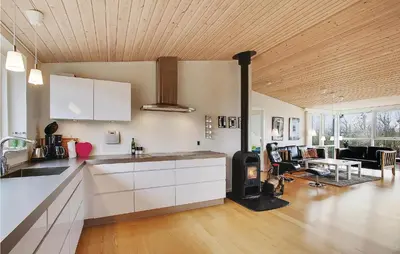 a kitchen with white cabinets and a living room at Awesome Home In Vinderup With Wifi in Vinderup