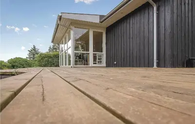 a house with a wooden deck in front of it at Awesome Home In Vinderup With Wifi in Vinderup