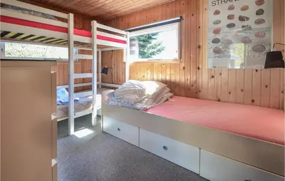a bedroom with two bunk beds and a window at Three-Bedroom Holiday Home In Spottrup in Spottrup