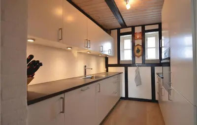 a kitchen with white cabinets and a sink at Three-Bedroom Holiday Home In Spottrup in Spottrup