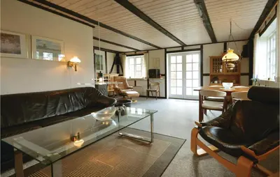 a living room with a couch and a glass table at Three-Bedroom Holiday Home In Spottrup in Spottrup