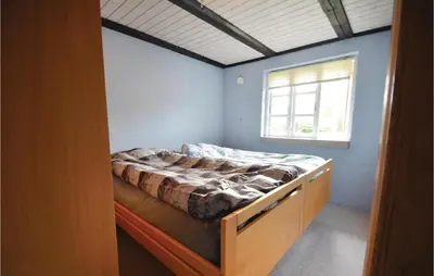 a bedroom with a bed in a room with a window at Three-Bedroom Holiday Home In Spottrup in Spottrup