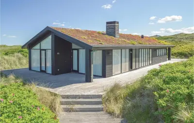 a house with a roof on top of a beach at Stunning Home In Løkken With Kitchen in Løkken