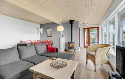 a living room with a couch and a table at Three-Bedroom Holiday Home In Farso in Farsø