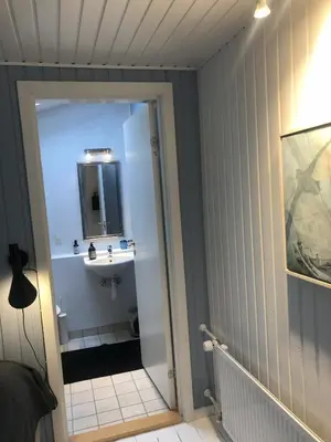 a bathroom with a sink and a mirror at Heltoften Bed & Breakfast in Nykøbing Mors