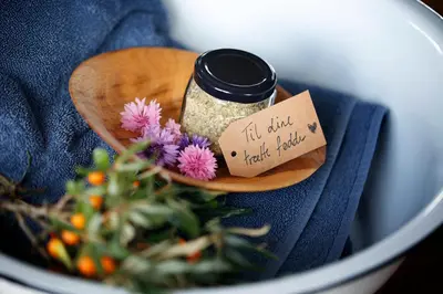 a jar of chia seeds and flowers in a bowl at Stenbjerg Kro & Badehotel in Snedsted