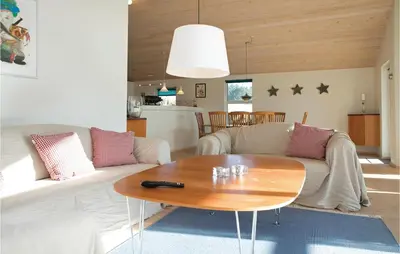 a living room with a couch and a table at Three-Bedroom Holiday Home In Blokhus in Blokhus