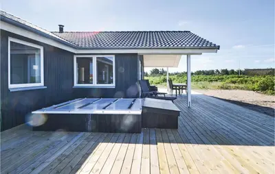 a deck with a hot tub on top of a house at Four-Bedroom Holiday Home In Vestervig in Vestervig