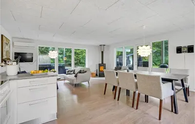 a kitchen and dining room with a table and chairs at Four-Bedroom Holiday Home In Spottrup in Spottrup